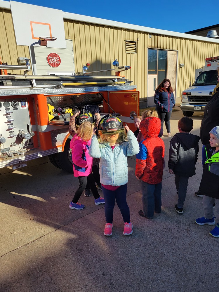Elementary students at career day with hats on.