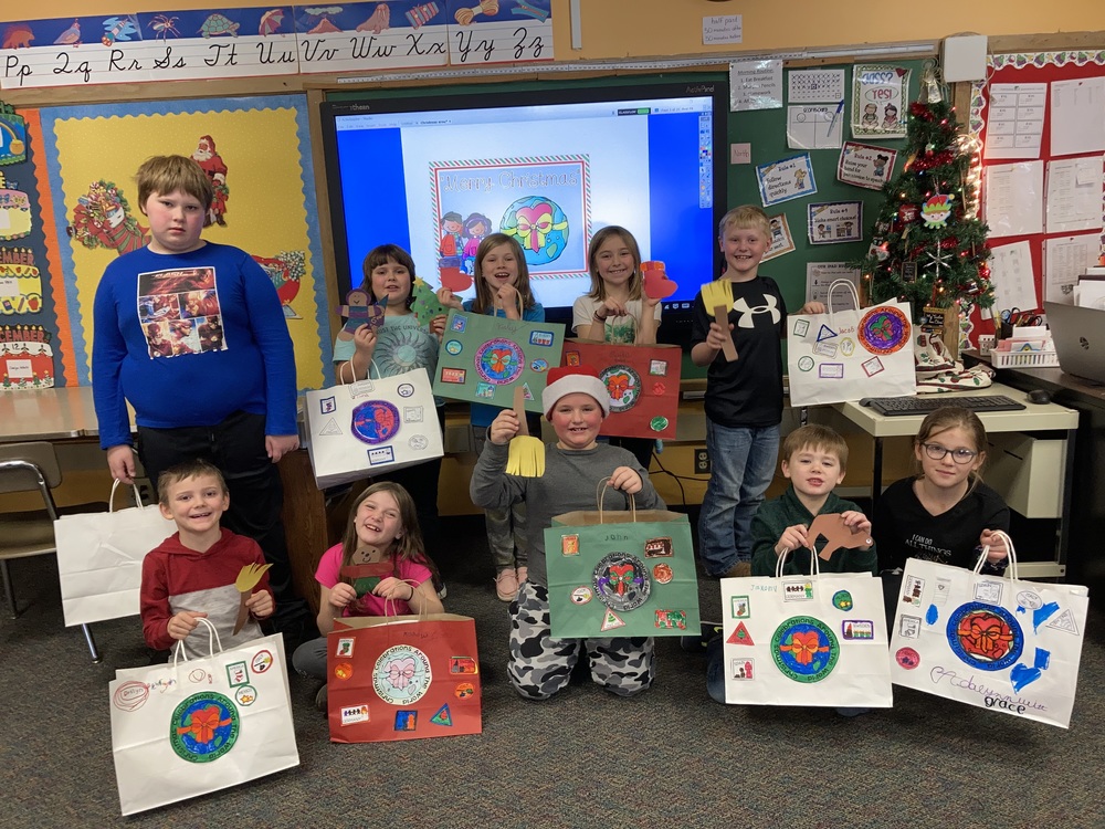 Ten 2nd grade students with decorated Christmas bags. 