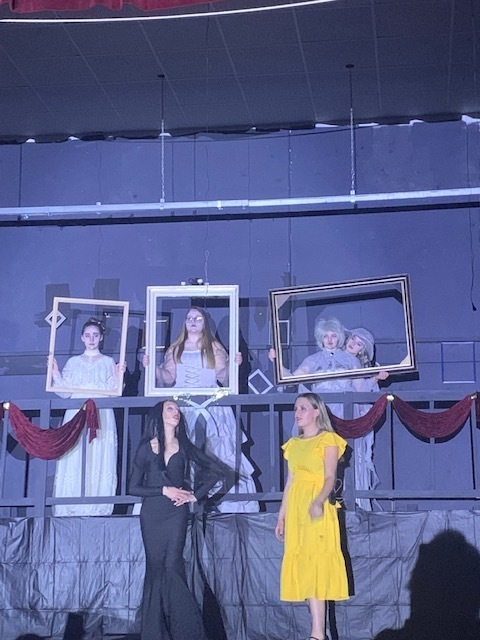 Six students on stage in costume.